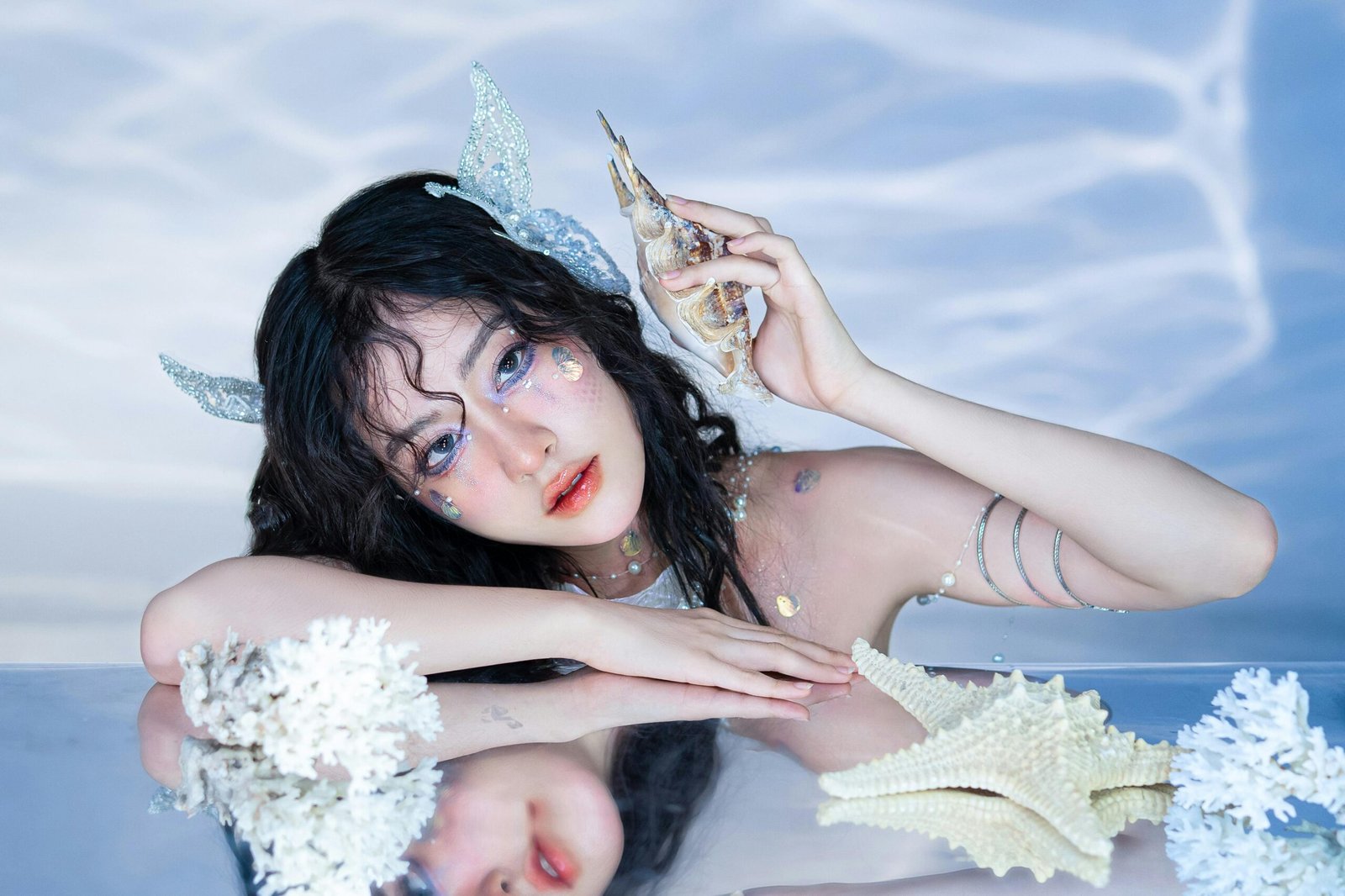 Woman Leaning on Mirror and Holding Starfish