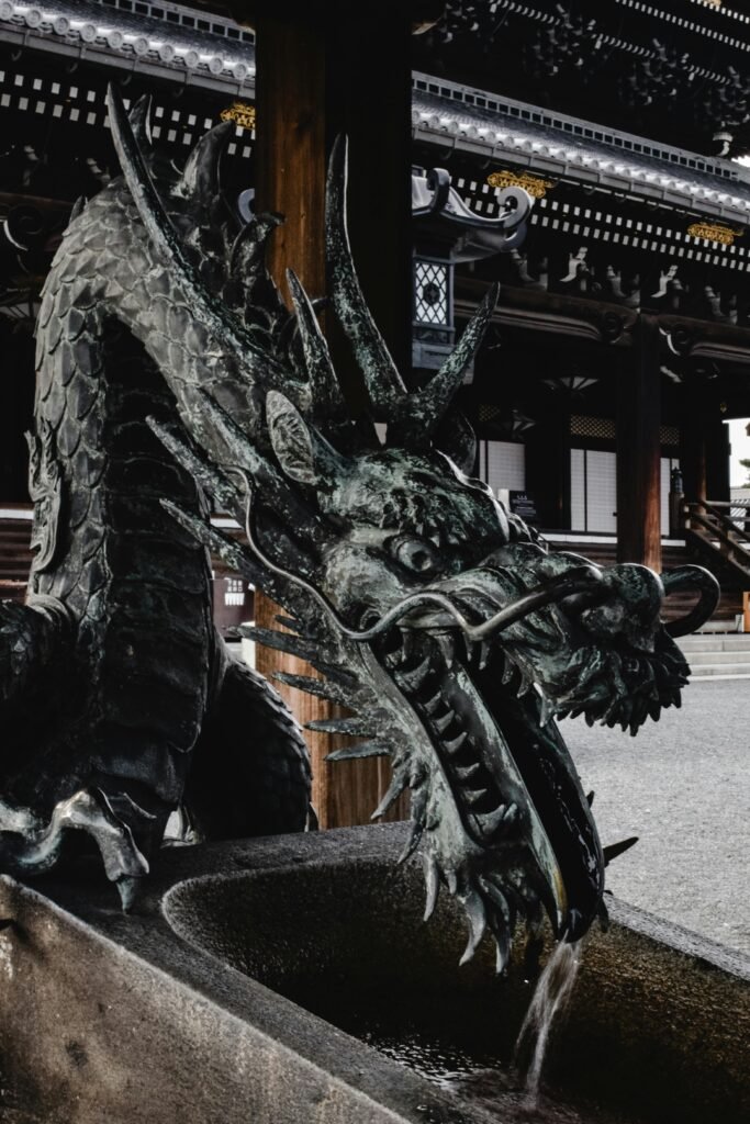 A detailed dragon sculpture fountain at a Buddhist temple in Kyoto, Japan.