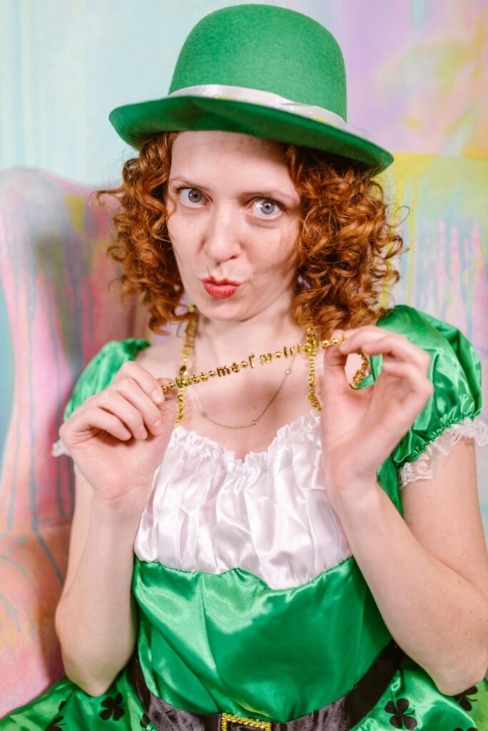 Caucasian woman in a green leprechaun costume celebrates St. Patrick's Day festivities indoors.